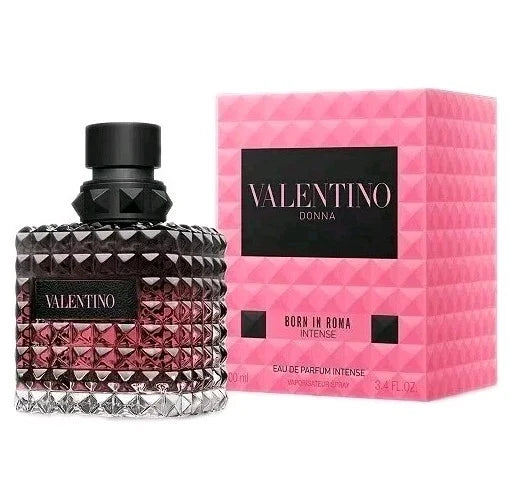 Valentino Donna Born in Roma Intense Eau de Parfum Intense bottle with a faceted dark glass body and black cap, shown next to its signature pink textured packaging box.