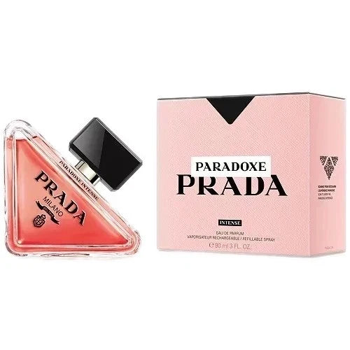 Prada Paradoxe Prada Intense perfume bottle next to its pink packaging box on a white background.